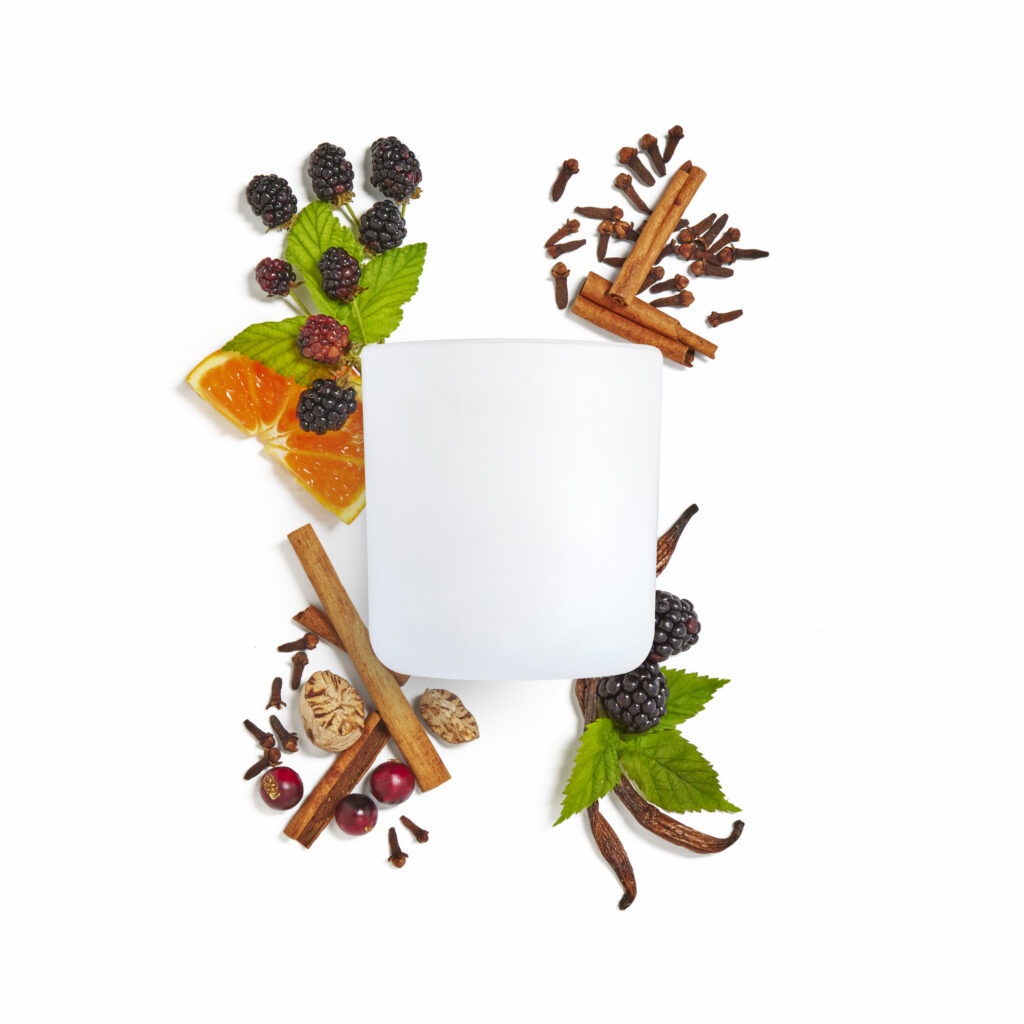 Cue Company candle jar with fresh fruit on white background