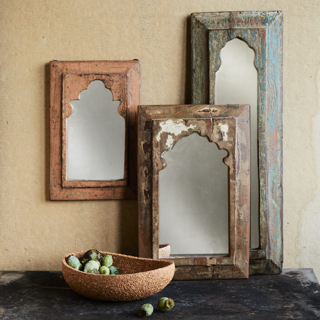 exotically framed mirrors on distressed background