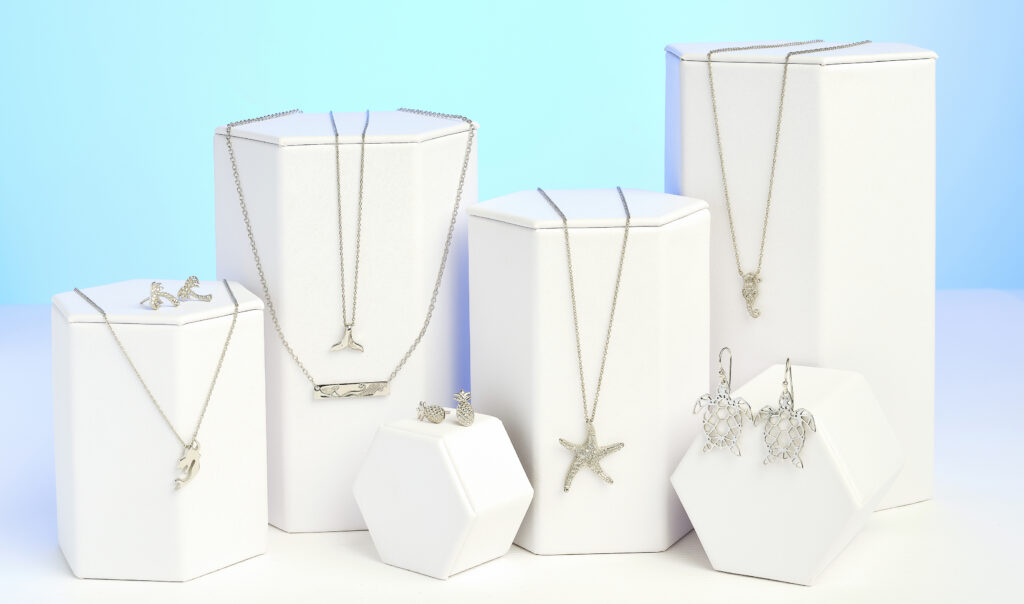 silver sea themed jewelry on a colorful aqua colored background