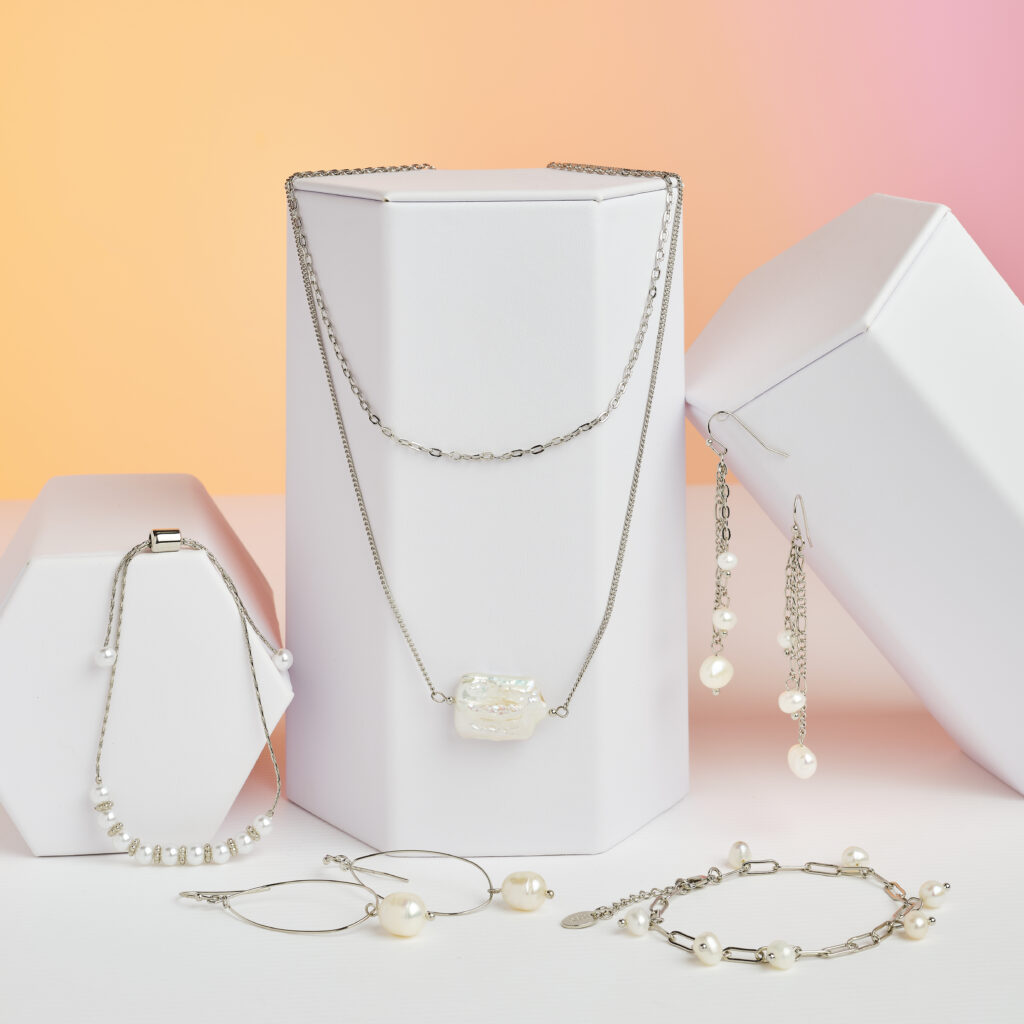 silver and pearl jewelry on a colorful peach colored background