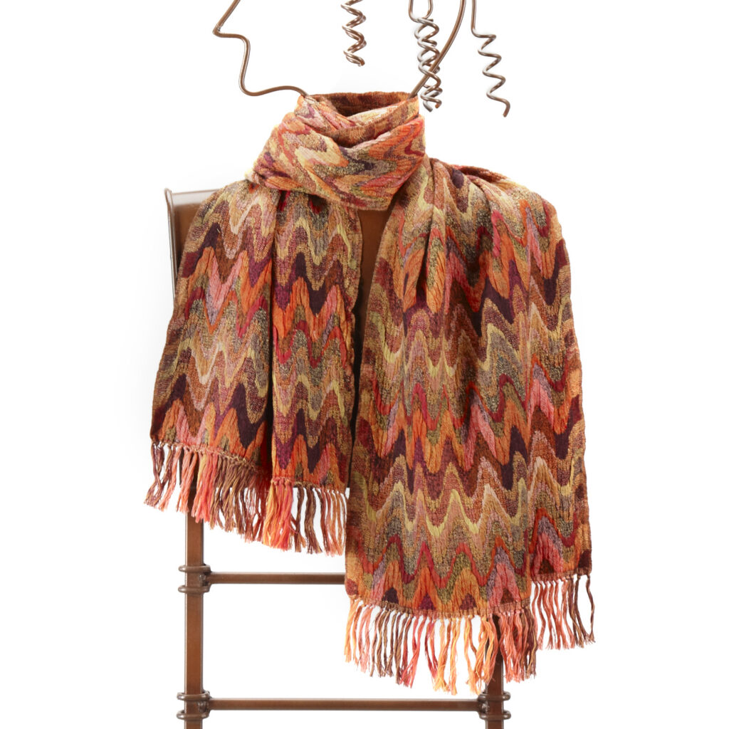 Colorful hand woven fair trade scarf on wire frame form on white background