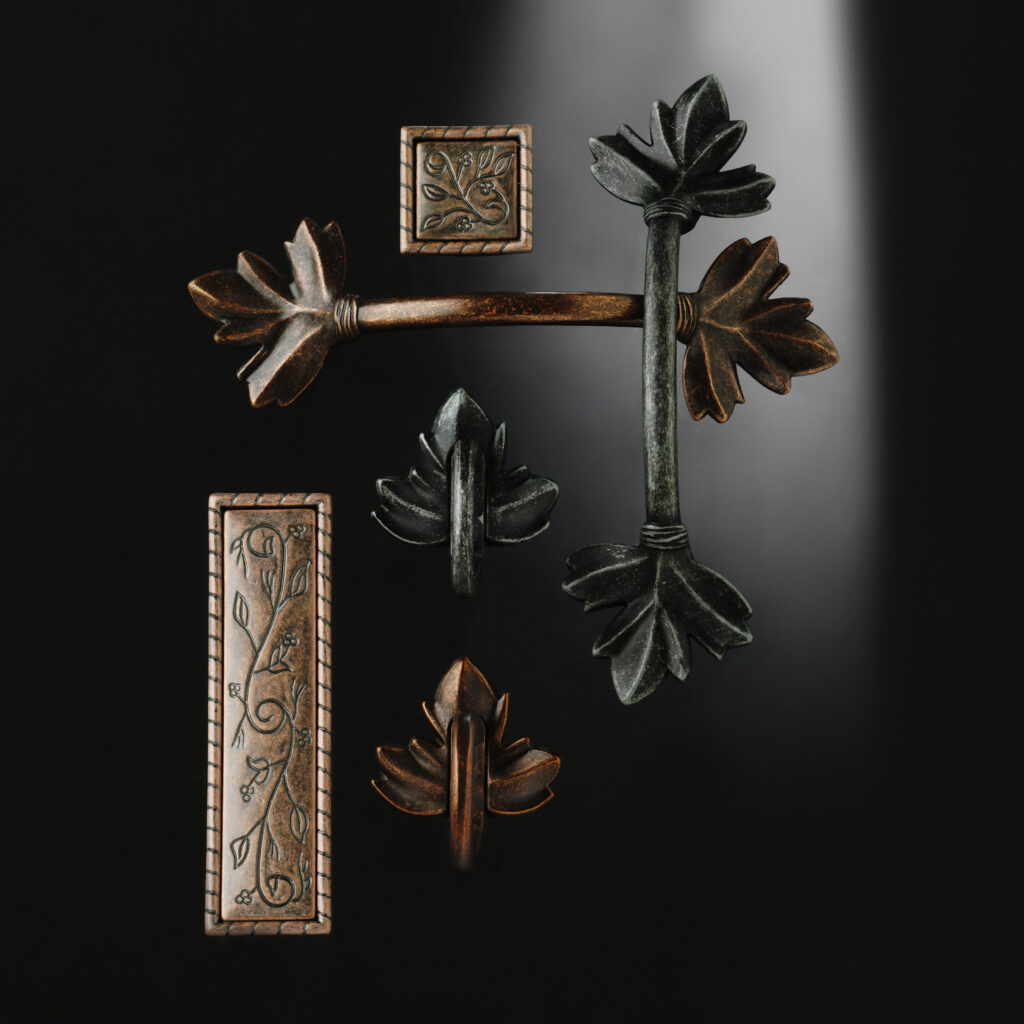 Amerock botanical hardware arranged on black background with dramatic lighting