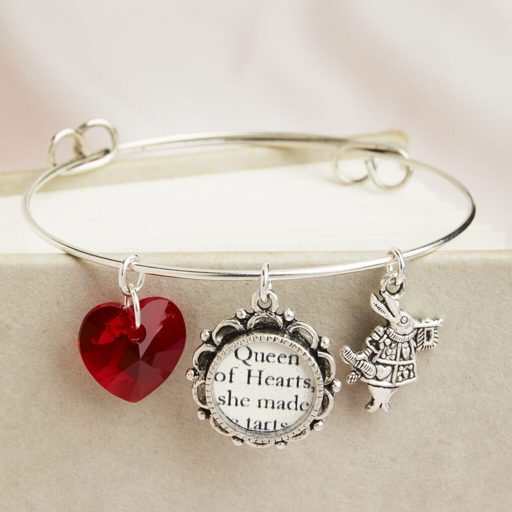 Queen of Hearts charm bracelet on book