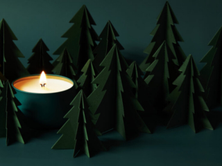 deep green forest of paper pine trees with deep green votive glowing yellow
