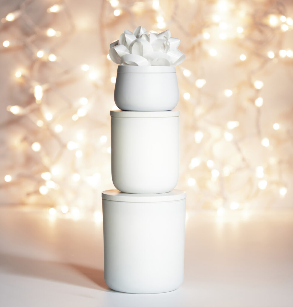 Cue Candle Company white candle stack with white bow and white twinkle lights