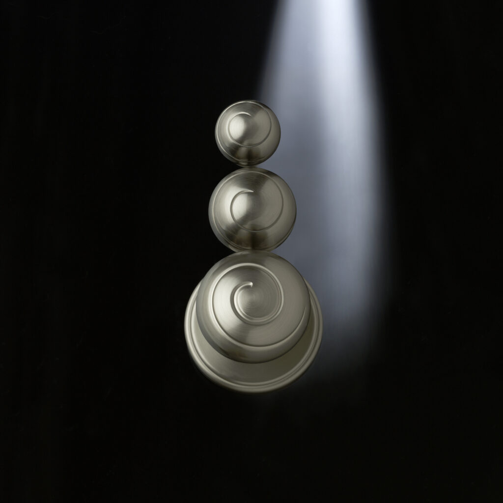Amerock satin nickel knobs arranged on black background with dramatic lighting