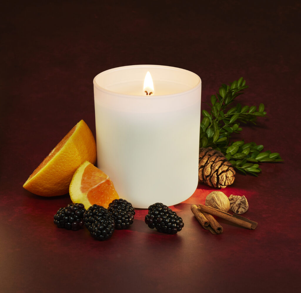 Cue Candle Company white candle with luscious fruit and spices on red background