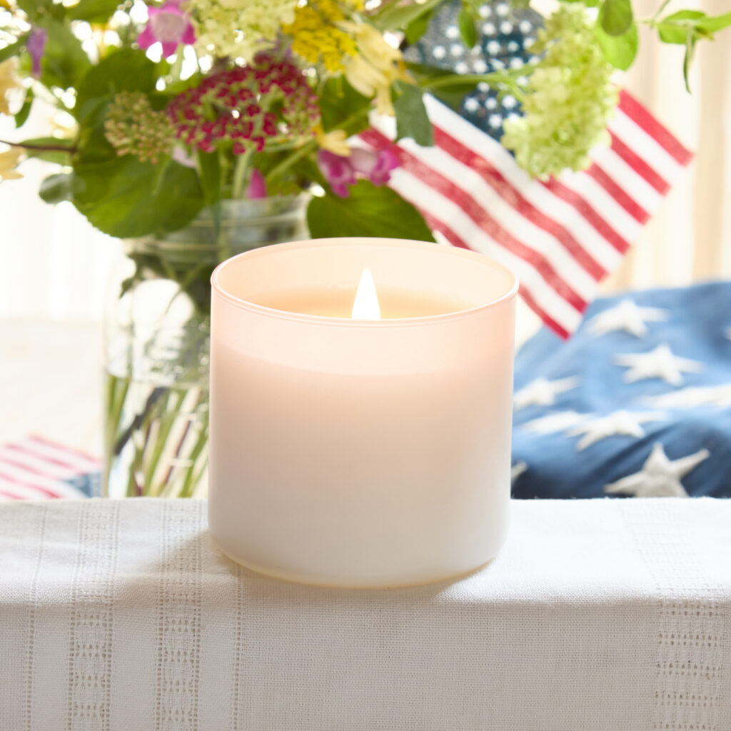 Cue Candle Company white candle jar with patriotic background