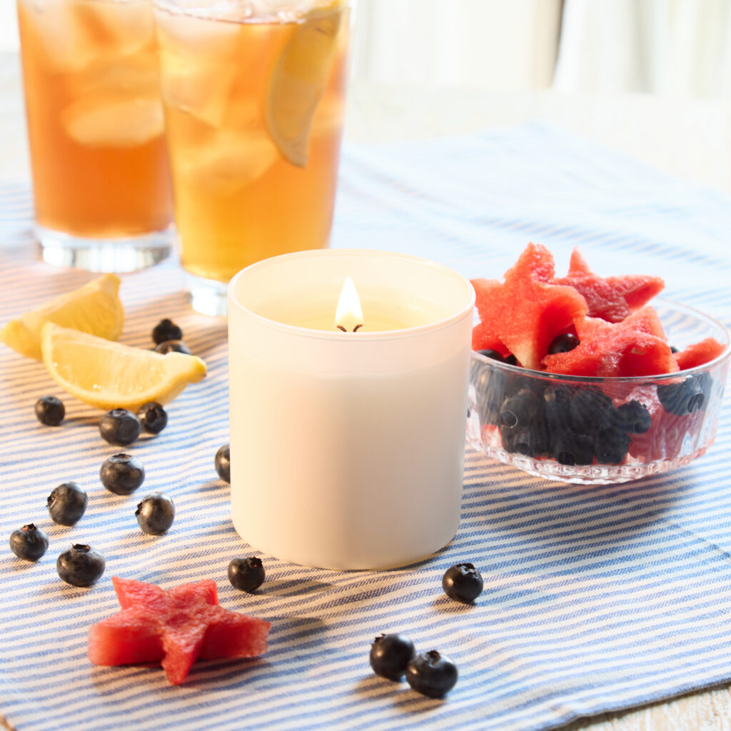 Cue Candle Company white candle jar with patriotic fruit salad and iced tea