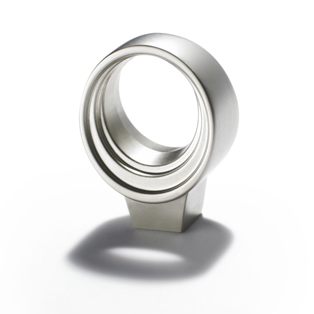 Amerock brushed nickel knob with dramatic shadow on white