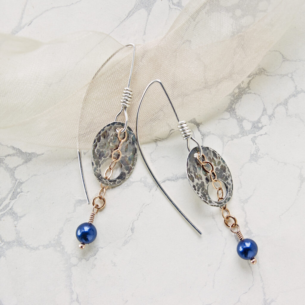 handcrafted earrings on marbled paper