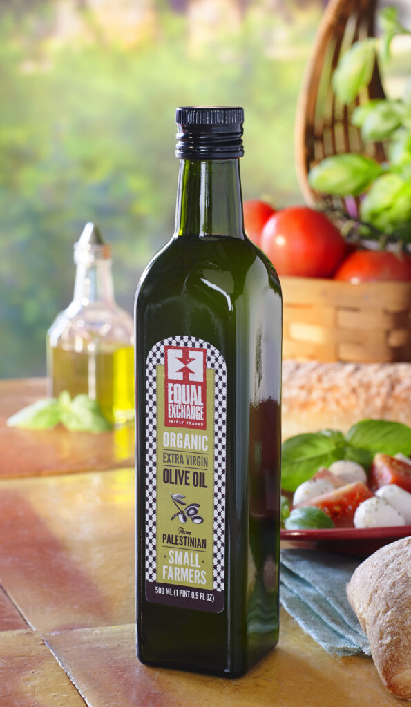 Equal Exchange bottle of olive oil with veggies on terra cotta tile