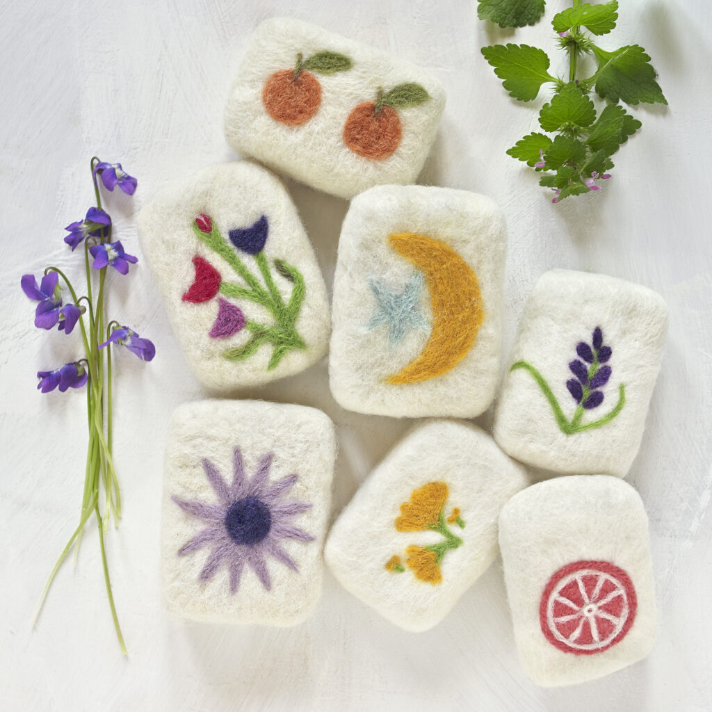 assorted felted soaps in whimsical designs with violets