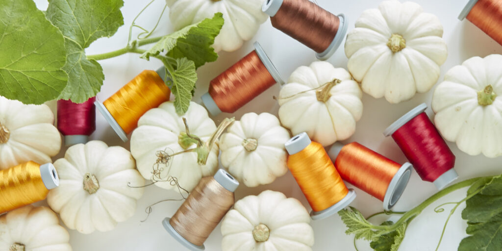 fall colored threads with white pumkins