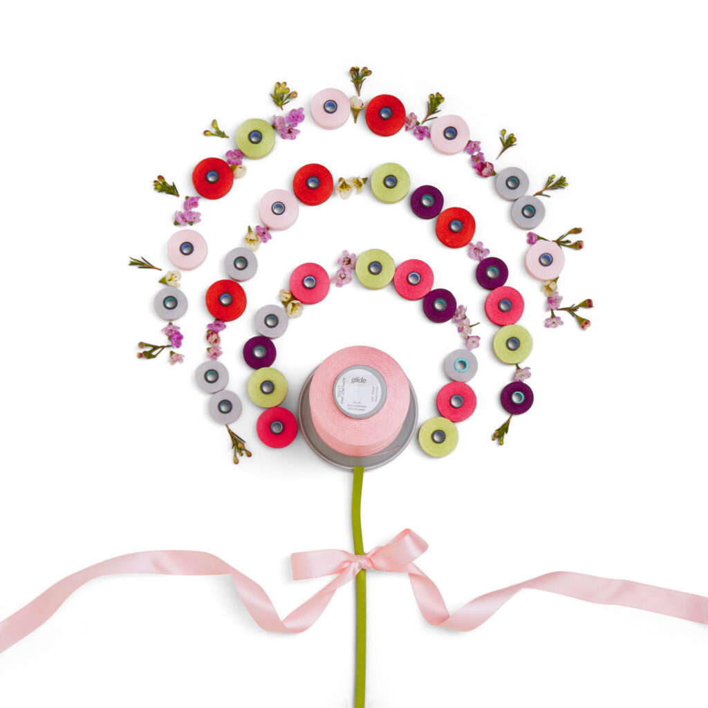 colorful threads set up to look like a giant lollipop with a pink bow