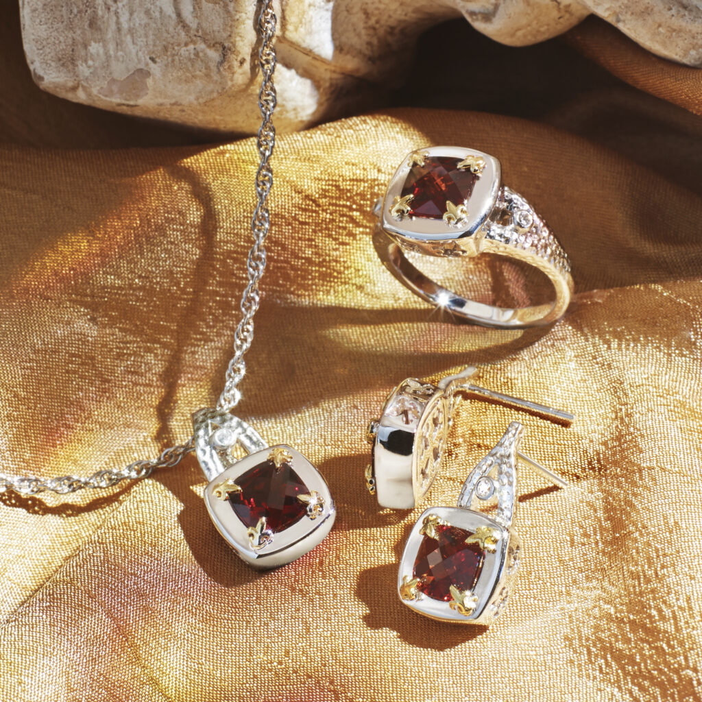 silver and garnet jewelry set on a gold background