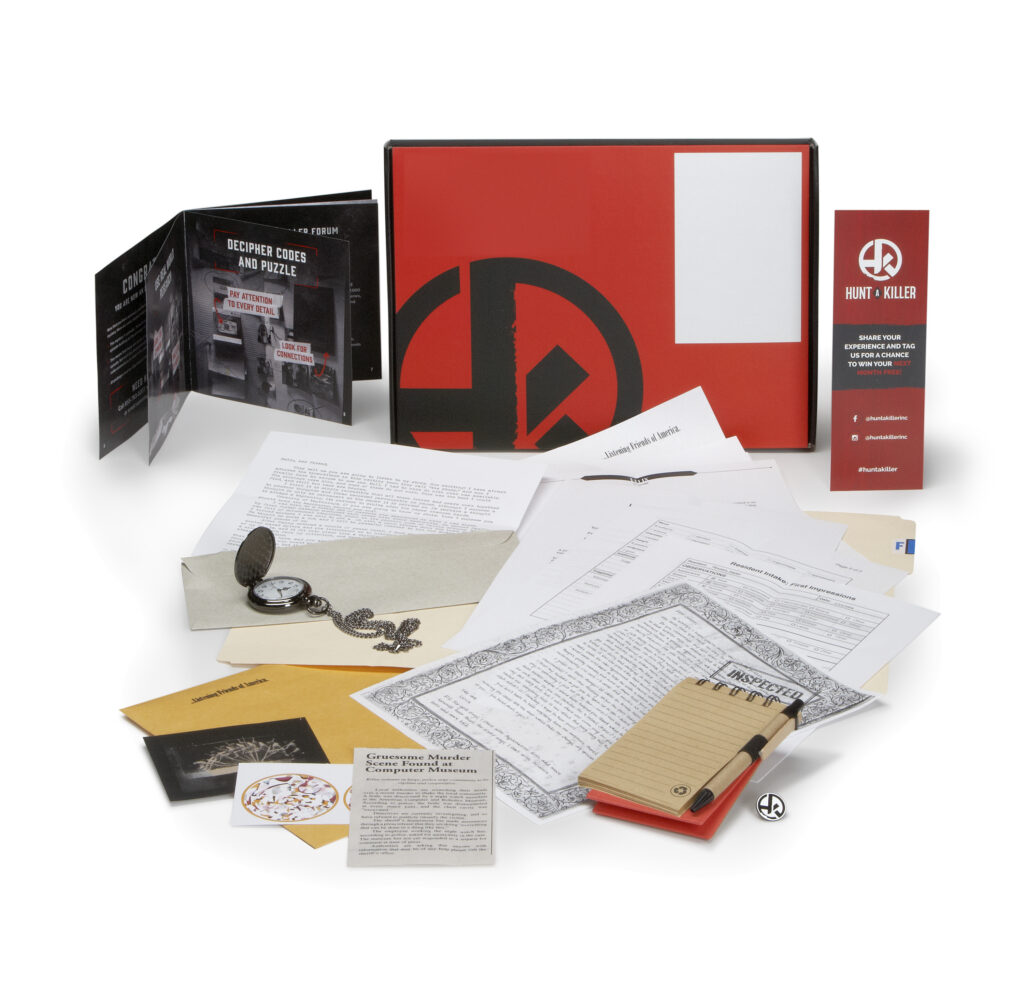 Hunt a Killer subscription box contents on white background
