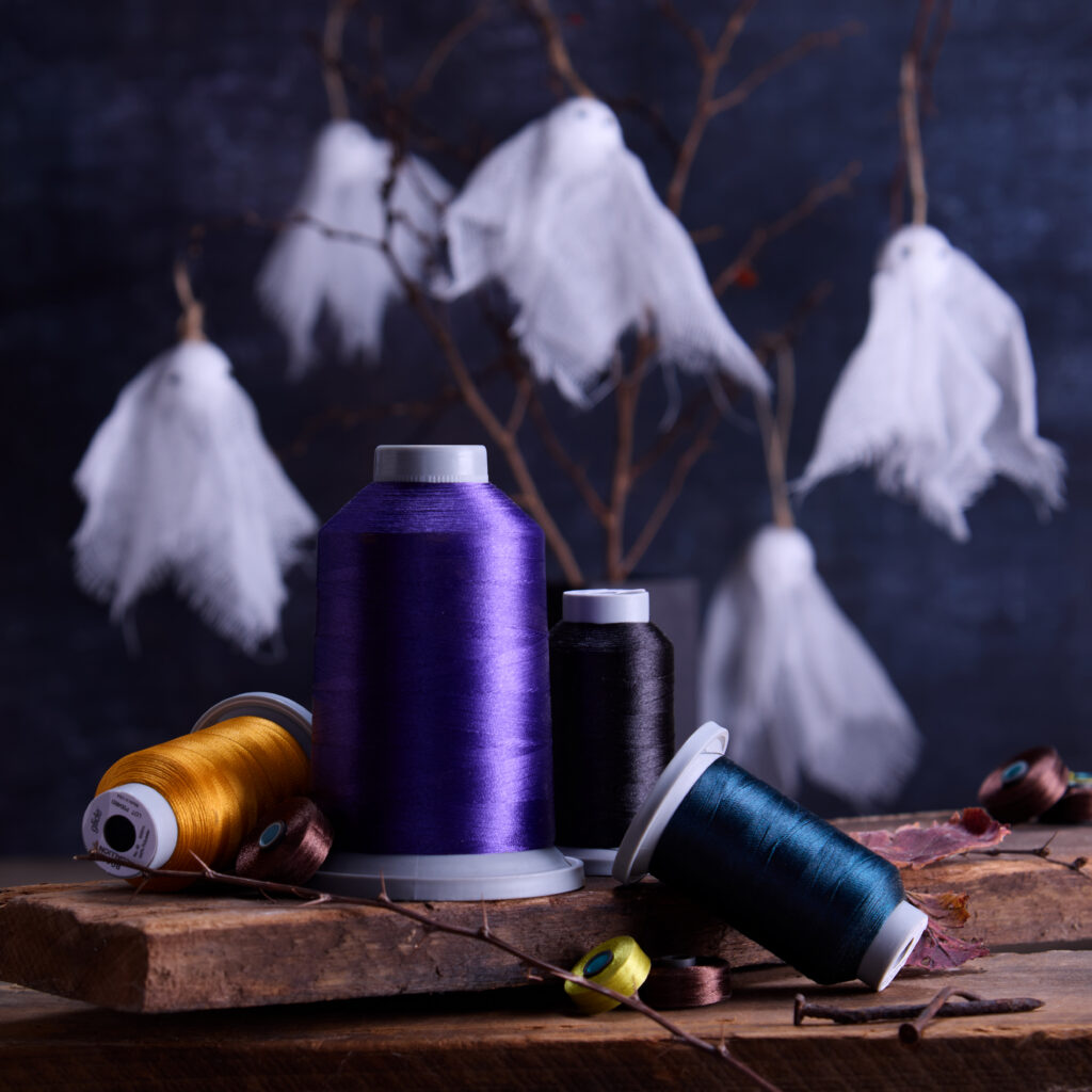 spooky photo of threads with halloween ghosts in the background