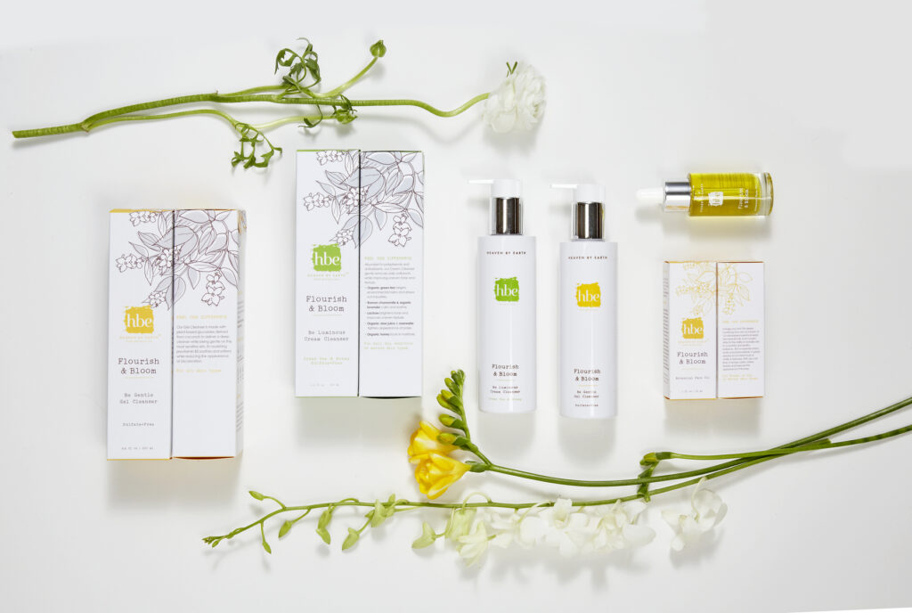 luxury beauty brand pachaging on white with yellow and white flowers