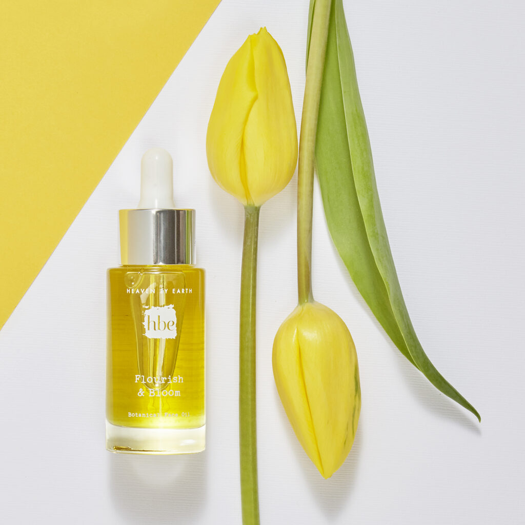luxury beauty brand botanical oil on white with yellow tulip