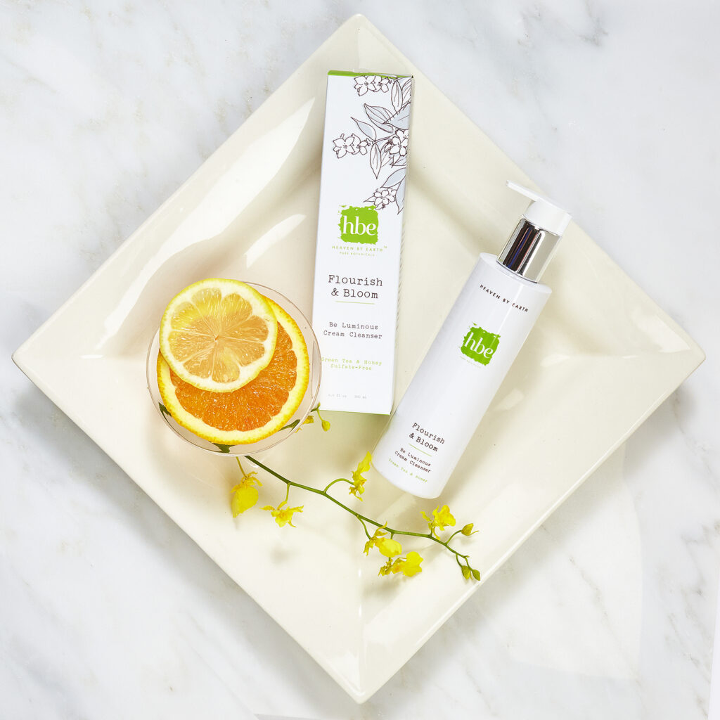luxury beauty brand items on square plate with fruit and flowers