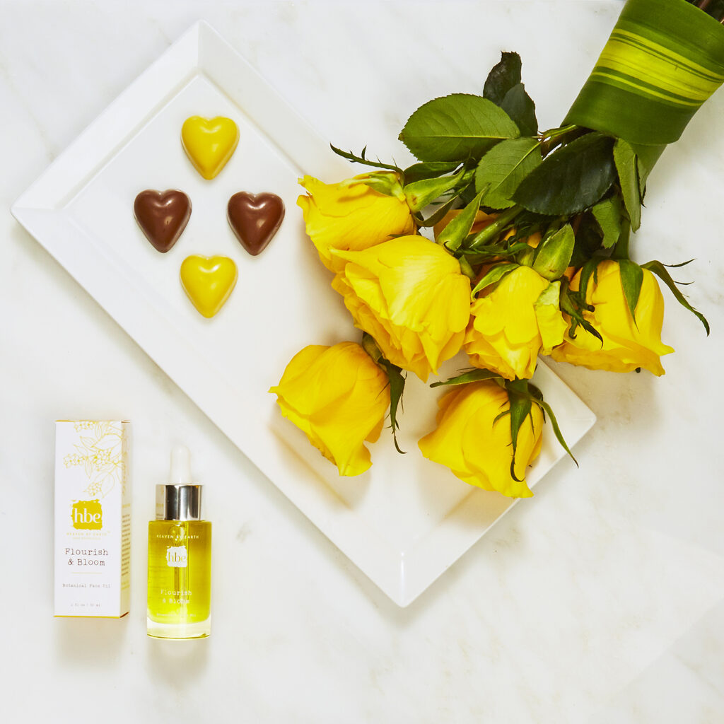 luxury beauty brand botanical oil on white with yellow roses