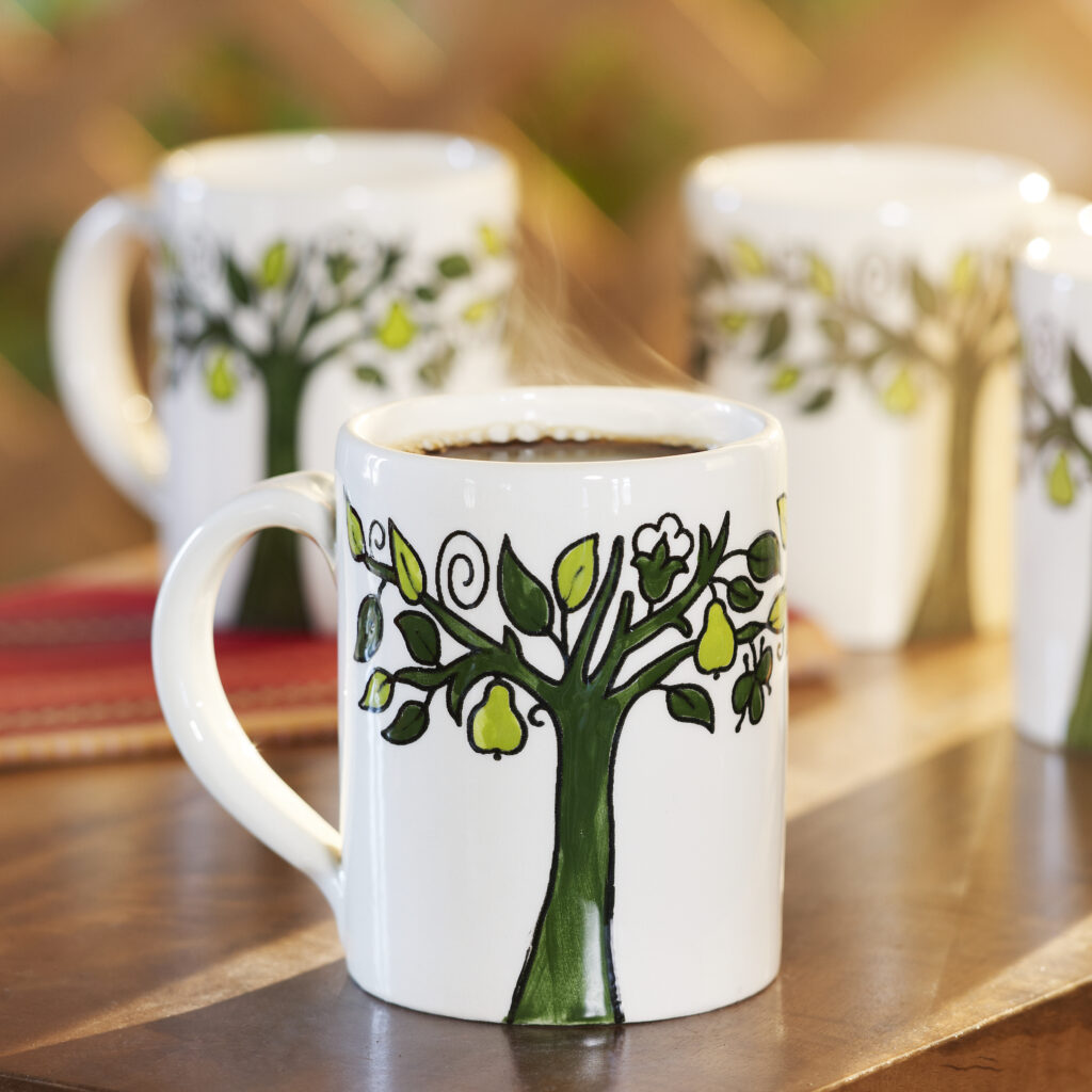 Fair trade ceramic mug of coffee with whimsical tree design