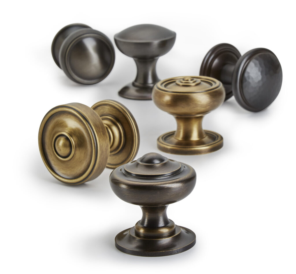 Michael Coldren, Co. various finishes of door knobs on white background