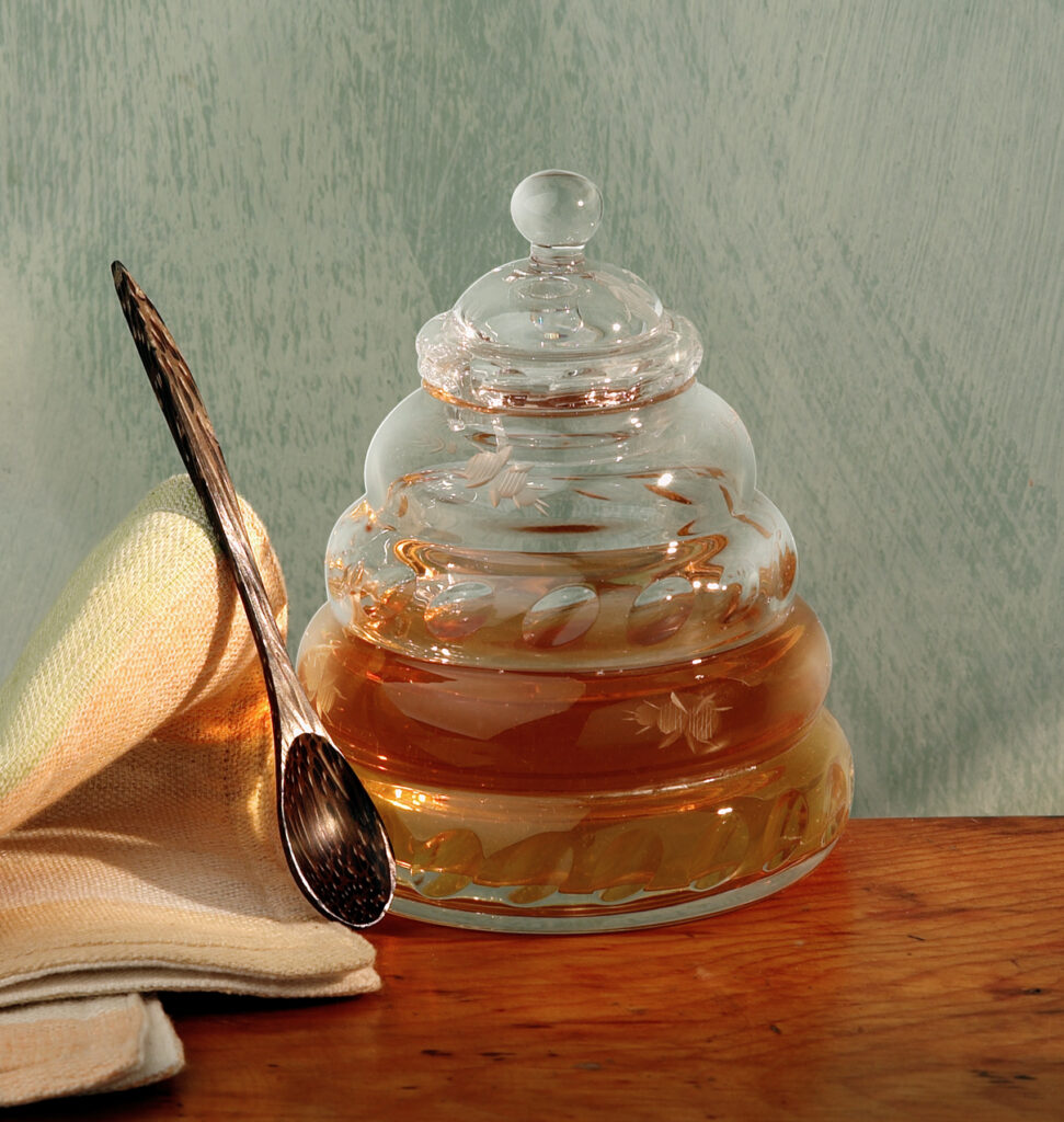 beautiful photo of honey jar and wooden spoon