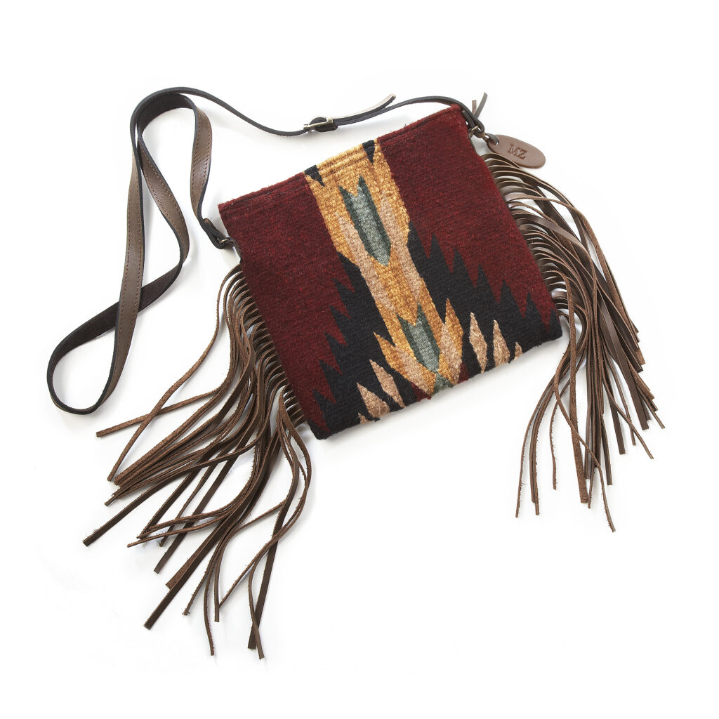 Colorful fair trade hand woven wool bag on white background