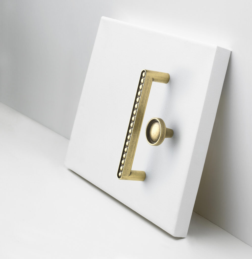 Amerock hardware arrange on a blank whitee canvas to convey a work of art