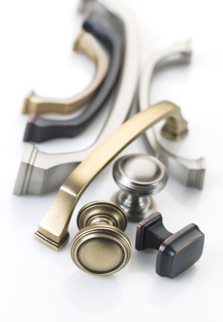 Amerock Revitalize hardware in various finishes artfully arranged together with soft lighting on a white background