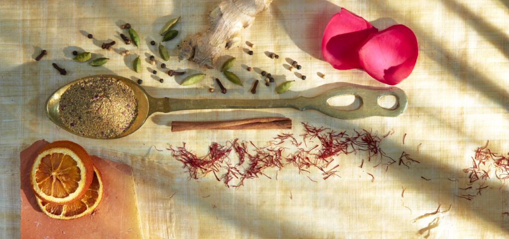 colorful photo of brass spoon with spices
