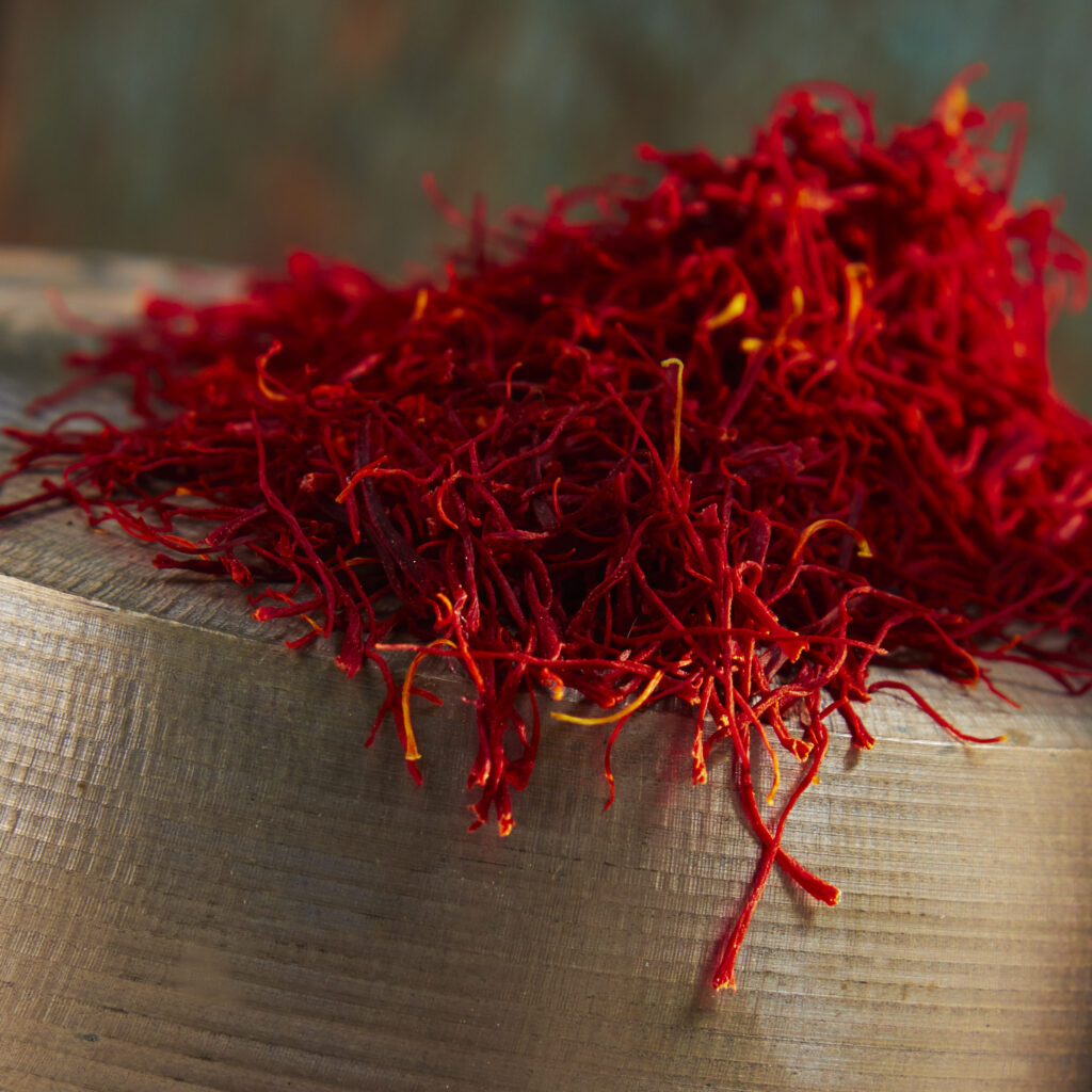 beautiful close up of saffron on edge of brass bowl
