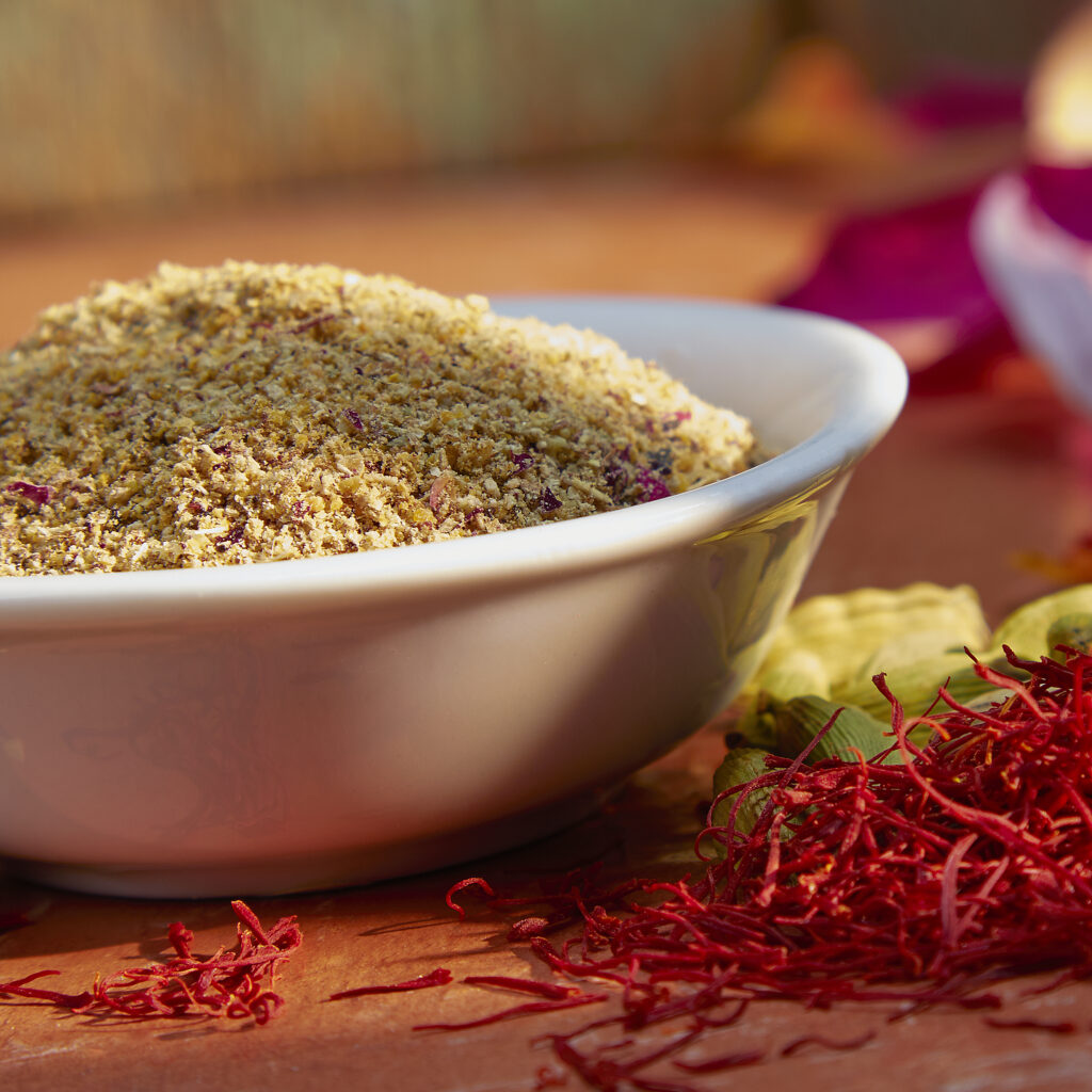 beautiful close up of spice blend in white bowl with saffron on colorful background