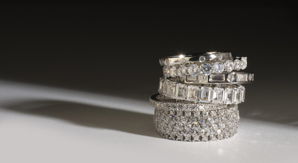 silver and diamond ring stack with dramatic lighting