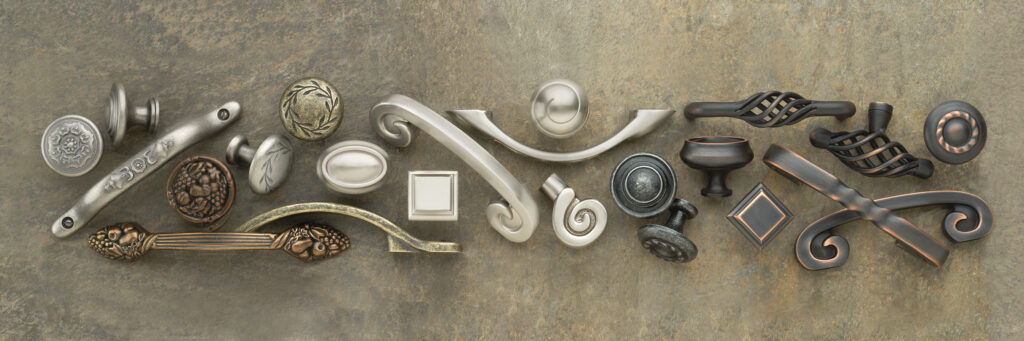Amerock hardware in various finishes and styles arranged in long scatter shot on slate