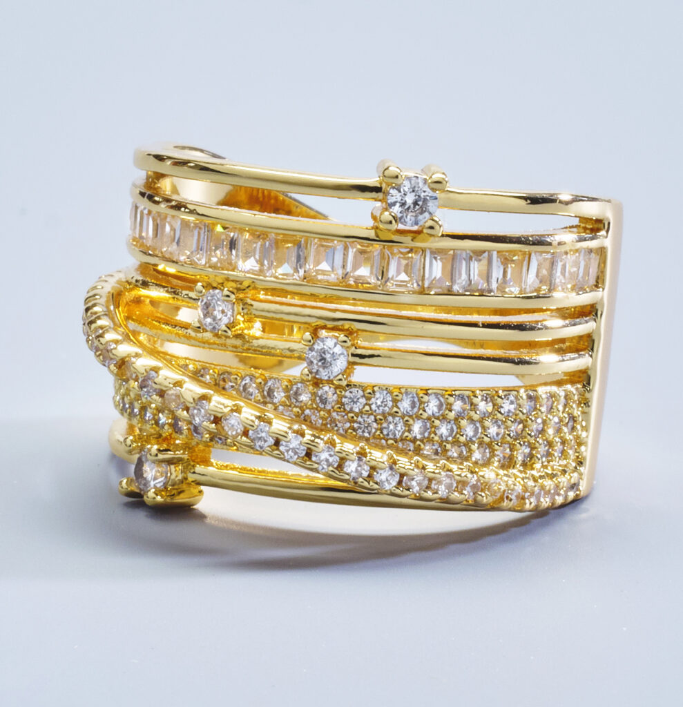 gold and diamond cocktail ring on soft blue background