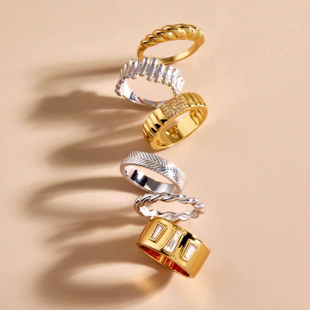 tumbling column of silver and gold rings with dramatic shadow