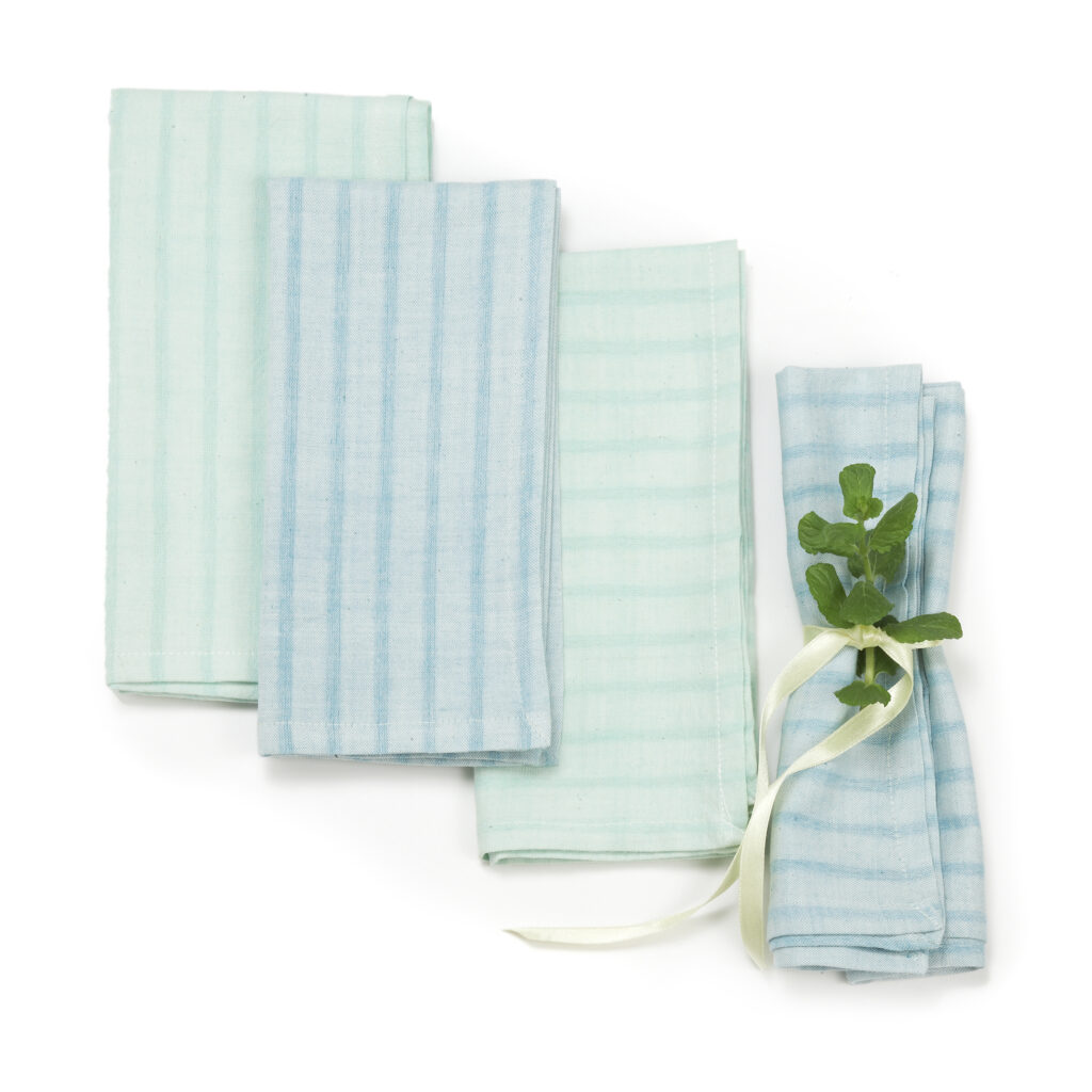 Sustainable Threads fair trade handwoven green and blue napkin set on white background