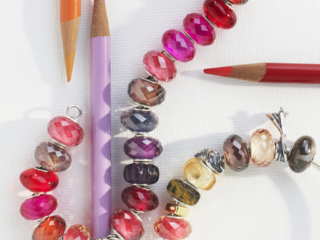 Whimsical pink and rose colored beads with bright colored pencils on canvas
