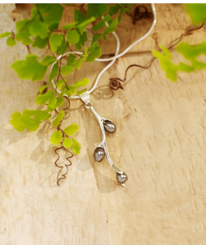 smokey pearl and silver fair trade pendant on romantic background