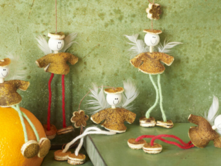 whimsical orange peel angels ornaments on distressed green background