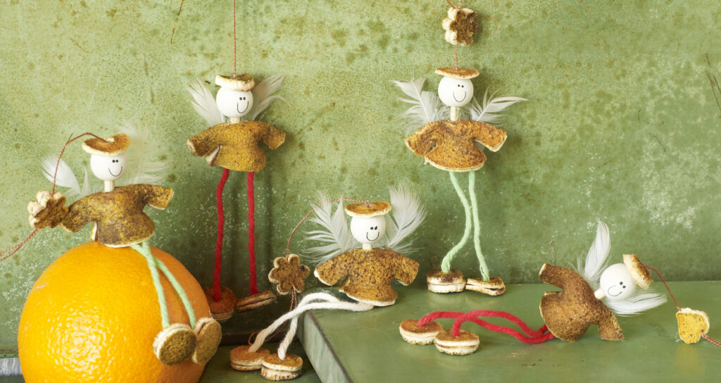 whimsical orange peel angels ornaments on distressed green background