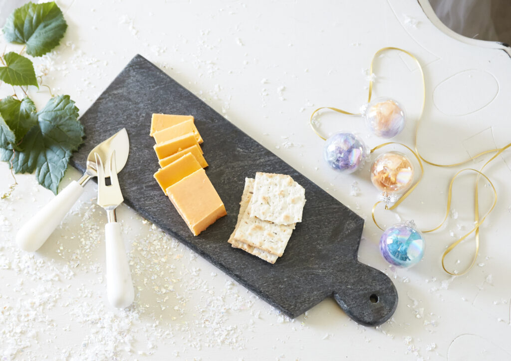 Fair trade slate cheese board and servers with holiday props