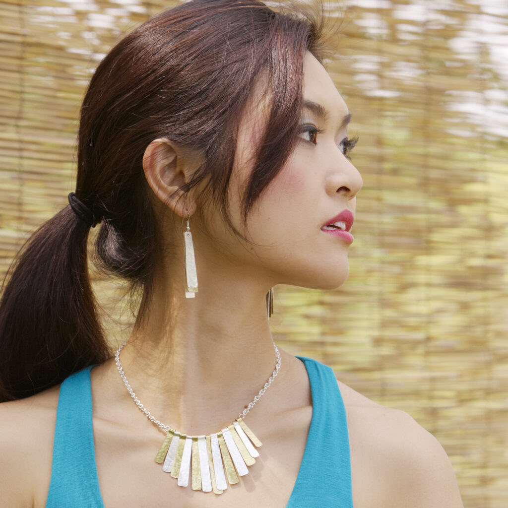 beautiful model wearing hammered metal fair trade jewelry