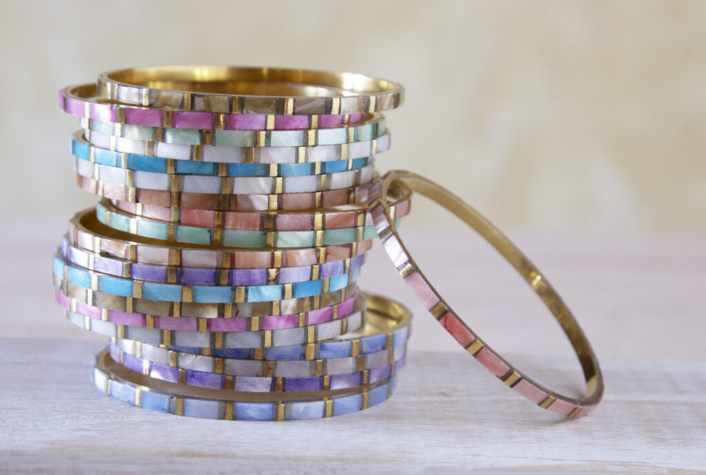 colorful mother of pearl  fair trade bangle bracelets in a stack