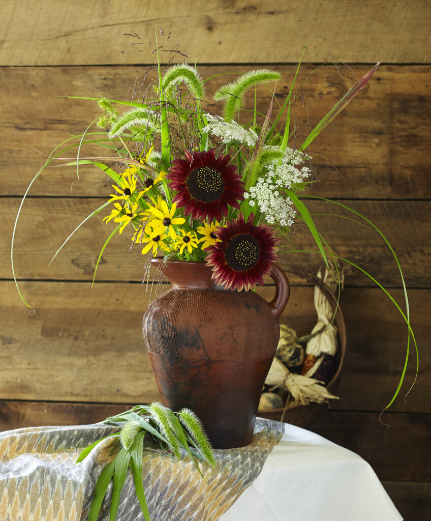 Fair Trade clay pitcher with fall flowers and barn wood