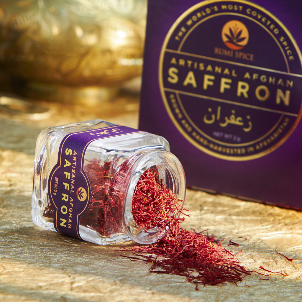 small jar of saffron spilling onto gold background