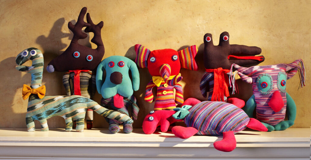 whimsical fair trade animal characters stuffed in colorful fabrics with button eyes